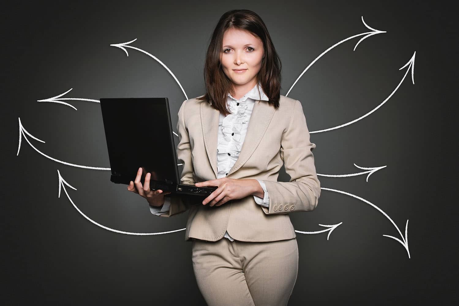 Professional woman using a laptop and sending emails